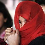 A girl covers her face with a scarf during class in the town of Kunjak in southern Afghanistan's Helmand province, February 21, 2011. REUTERS/Finbarr O'Reilly