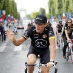 Radioshack team rider Lance Armstrong of the U.S. waves on the Champs Elysees during the final parade of the 97th Tour de France cycling race in Paris July 25, 2010. REUTERS/Francois Lenoir