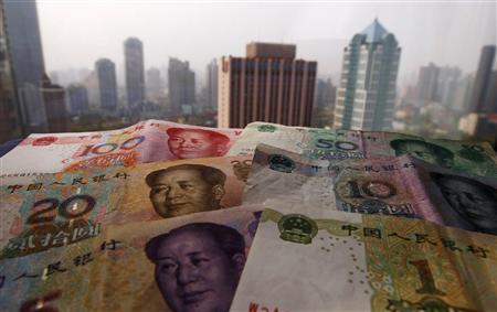 File photo illustration of different values of China's yuan banknotes placed on a window sill as Shanghai's skyscrapers are seen in the background Different values of China's yuan banknotes are placed on a window sill as Shanghai's skyscrapers are seen in the background, in this April 15, 2012 file photo illustration taken in Shanghai. REUTERS/Petar Kujundzic/Files