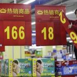 An employee changes a price label at a supermarket in Wuhan, Hubei province March 9, 2012. REUTERS/Stringer