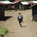 A government soldier runs through the deserted town of Rutsiro near the front line in eastern Congo, June 1, 1012. REUTERS/Jonny Hogg