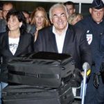 Former IMF chief Dominique Strauss-Kahn (C) and his wife Anne Sinclair (2nd L) arrive at Charles-de-Gaulle airport in Roissy near Paris September 4, 2011. REUTERS/Eric Gaillard