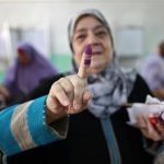 A woman shows her ink-stained finger after casting her vote at a polling station in Cairo June 16, 2012. REUTERS/Suhaib Salem