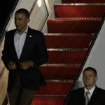 U.S. President Barack Obama walks down a staircase after landing at the airport in Los Cabos June 17, 2012. Obama arrived in the Pacific resort of Los Cabos on Sunday to attend the G20 summit, which will kick off on Monday. REUTERS/Henry Romero