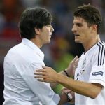 Germany's Mario Gomez (R) shakes hands with his coach Joachim Loew as he leaves the pitch during their Group B Euro 2012 soccer match against Netherlands at the Metalist stadium in Kharkiv, June 13, 2012. REUTERS/Thomas Bohlen