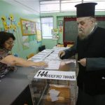 A Greek Orthodox priest casts his ballot at an Athens primary school used as a polling station June 17, 2012. REUTERS/Yannis Behrakis
