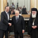 Newly appointed Greek Prime Minister Antonis Samaras (L) shakes hands with President Karolos Papoulias (C) as Greece's Orthodox Archbishop Ieronymos looks on after a swearing in ceremony at the Presidential palace in Athens June 20, 2012. Samaras pledged to pull his debt-stricken country back from the brink of bankruptcy on Wednesday in his first comments after being sworn in. REUTERS/Yorgos Karahalis