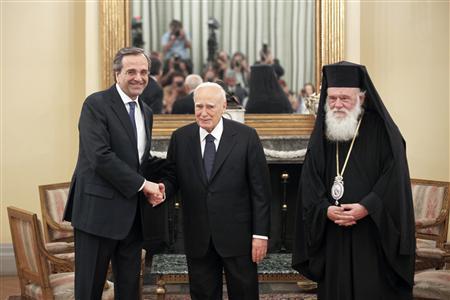 Newly appointed Greek Prime Minister Samaras shakes hands with President Papoulias as Greece's Orthodox Archbishop Ieronymos looks on after a swearing in ceremony in Athens Newly appointed Greek Prime Minister Antonis Samaras (L) shakes hands with President Karolos Papoulias (C) as Greece's Orthodox Archbishop Ieronymos looks on after a swearing in ceremony at the Presidential palace in Athens June 20, 2012. Samaras pledged to pull his debt-stricken country back from the brink of bankruptcy on Wednesday in his first comments after being sworn in. REUTERS/Yorgos Karahalis