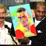 Undisputed middleweight champion Bernard Hopkins (R) holds up a portrait of himself painted by artist LeRoy Neiman (L) during a post-fight press conference at the MGM Grand Garden Arena in Las Vegas, Nevada September 18, 2004. REUTERS/Ethan Miller SM/DL