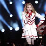 Madonna’s regression continues as she dresses as a cheerleader and shows off her bum