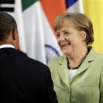 U.S. President Barack Obama (L) and German Chancellor Angela Merkel talk during the group photo session of the G20 Summit in Los Cabos June 18, 2012. REUTERS/Andres Stapff