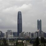 Container trucks cross a bridge in front of the 100-floor Kingkey 100, the tallest building in downtown Shenzhen neighboring Hong Kong, May 16, 2012. REUTERS/Bobby Yip