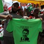 Supporters of Muslim Brotherhood's presidential candidate Mohamed Morsy display a t-shirt with a picture of Morsy during a rally against the delay of the Egyptian presidential results and against the Supreme Council for the Armed Forces (SCAF) at Tahrir Square in Cairo June 22, 2012. REUTERS/Amr Abdallah Dalsh