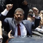 Presidential candidate Mohamed Morsy of the Muslim Brotherhood waves to his supporters after casting his vote at a polling station in a school in Al-Sharqya, 60 km (37 miles) northeast of Cairo in this June 16, 2012 file photo. REUTERS/Ahmed Jadallah/Files
