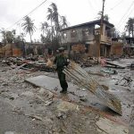 A soldier removes debris from a road in a neighbourhood that was burnt during recent violence in Sittwe June 14, 2012. The violence had killed 21 people as of Monday, state media said, but activists fear the death toll could be much higher. At least 1,600 houses have been burnt down. The army has taken hundreds of Rohingyas to Muslim villages outside Sittwe to ensure their safety. Places that were flashpoints earlier in the week, including the state capital Sittwe, were quiet as violence started to subside after days of arson attacks and killing that have presented reformist President Thein Sein with one of his biggest challenges since taking office last year. REUTERS/Soe Zeya Tun