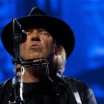 Neil Young performs as a surprise guest musician at the Robin Hood Foundation Benefit at the Jacob K Javits Convention Center in New York May 14, 2012. REUTERS/Andrew Kelly