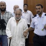 Deposed Libyan leader Muammar Gaddafi's former prime minister Al Baghdadi al-Mahmoudi (C) is escorted in the office of his prison guard in Tripoli after being extradited from Tunis June 24, 2012. REUTERS/Anis Mili