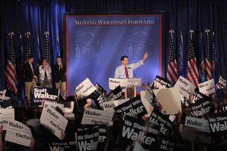 Republican Wisconsin Governor Walker celebrates his victory in the recall election against Democratic challenger and Milwaukee Mayor Barrett in Waukesha, Wisconsin Republican Wisconsin Governor Scott Walker (C) waves as he celebrates his victory in the recall election against Democratic challenger and Milwaukee Mayor Tom Barrett in Waukesha, Wisconsin June 5, 2012. The rematch with Milwaukee's Democratic Mayor Barrett, who Walker defeated in a Republican sweep of the state in 2010, is the end-game of six months of bitter fighting in the Midwestern Rust Belt state over the union restrictions Walker proposed and enacted. REUTERS/Darren Hauck