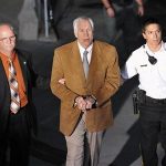 Former Penn State assistant football coach Jerry Sandusky leaves the Centre County Courthouse in handcuffs after his conviction in his child sex abuse trial in Bellefonte, Pennsylvania, June 22, 2012. REUTERS/Pat Little
