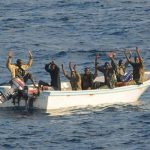 Suspected pirates keep their hands in the air as they are being apprehended by the U.S. Navy aboard the guided-missile cruiser USS Vella Gulf (CG 72) in Gulf of Aden, Somalia, February 11, 2009REUTERS/Jason R. Zalasky/U.S. Navy photo/Handout