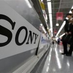 A Sony logo is seen as customers look at Sony's digital cameras at an electronic shop in Tokyo May 10, 2012. REUTERS/Kim Kyung-Hoon