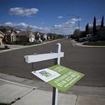 A realty sign swings in the wind in the Weston Ranch neighborhood of Stockton, California, March 6, 2012. REUTERS/Max Whittaker