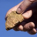 A piece of bastnasite ore, which contains rare earth elements, is shown by Brock O'Kelly from Molycorp Minerals Mountain pass Mine in Mountain Pass, California in this August 19, 2009, file photo. REUTERS/David Becker/Files
