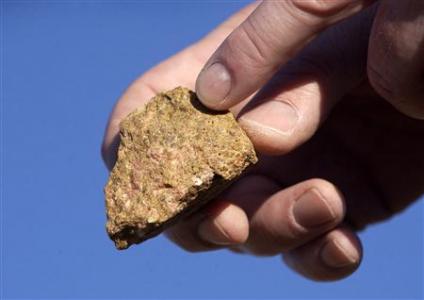 A piece of bastnasite ore, which contains rare earth elements, is shown by Brock O'Kelly from Molycorp Minerals Mountain pass Mine in Mountain Pass, California in this August 19, 2009, file photo. REUTERS/David Becker/Files