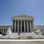 People stand at the foot of the steps of the Supreme Court in Washington May 20, 2009. REUTERS/Molly Riley