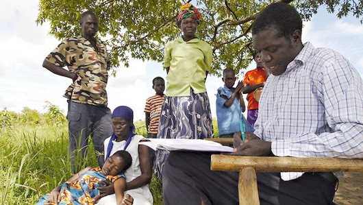 Alfred Ojara, right, logs information on patients he treats with traditional methods. For nodding disease, he offers a tonic of water and vine root. Alfred Ojara, right, logs information on patients he treats with traditional methods. For nodding disease, he offers a tonic of water and vine root.