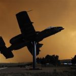 An A-10 aircraft on static display is silhouetted against a smoke cloud from the Waldo Canyon Fire at the USAF Academy's airfield in Colorado Springs, Colorado in this U.S. Air Force handout photo dated June 26, 2012. REUTERS/U.S. Air Force/Mike Kaplan/Handout