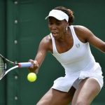 Venus Williams of the U.S. hits a return to Elena Vesnina of Russia during their women's singles tennis match at the Wimbledon tennis championships in London June 25, 2012. REUTERS/Toby Melville