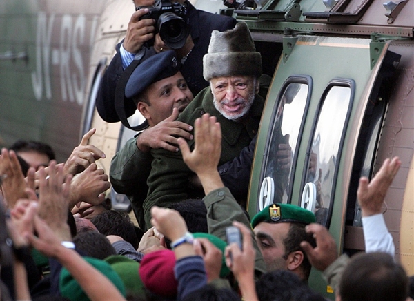 120704-arafat-330a.photoblog600 Ailing Palestinian leader Yasser Arafat says goodbye to well-wishers as he leaves Ramallah on October 29, 2004. He was flown to Paris to seek medical treatment, but died less than two weeks late