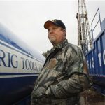 Kevin B. Koonce, a landman who worked cancelling leases in Michigan on behalf of Chesapeake Energy Corporation, stands near a drilling rig in Etoile, Texas in this December 26, 2011 file photo. REUTERS/Mike Stone