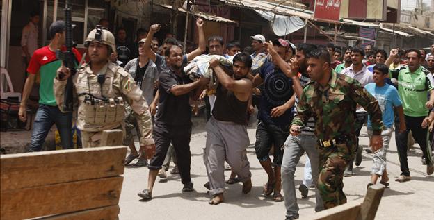 People carry the body of a victim of a car bomb attack in the Washash neighborhood of Baghdad, Iraq, on Thursday. People carry the body of a victim of a car bomb attack in the Washash neighborhood of Baghdad, Iraq, on Thursday.