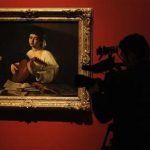 A cameraman films the "Lute Player", a painting by artist Michelangelo Merisi da Caravaggio, during the media preview of "The Hermitage in the Prado" exhibition at the Prado Museum in Madrid November 4, 2011. REUTERS/Andrea Comas