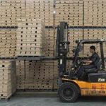 A worker operates a forklift to transport floor boards at a wood flooring factory in Huzhou, Zhejiang province July 13, 2012. REUTERS/Sean Yong