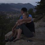 Local residents Lindsay Hetzel and Nathan Birdseye sit on a cliff over looking the Waldo Canyon Fire in Colorado Springs, Colorado June 30, 2012. Crews battling a deadly Colorado wildfire ranked the most destructive in state history have made enough headway to allow most evacuees home, but concerns remain about rogue bears and burglaries in vacant houses, officials said on Saturday. The wildfire has been blamed for two deaths and the destruction of 346 homes, while 35,000 residents were forced to evacuate to escape the threat of flames and heavy smoke. REUTERS/Adrees Latif