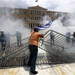 A protester taunts police in front of the parliament during violent protests in Athens' Syntagma square in this June 29, 2011 file photograph. REUTERS/Yannis Behrakis/Files