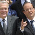 France's President Francois Hollande (R) and Prime Minister Jean-Marc Ayrault pose for the traditional family photo of the government after a minor government reshuffle outside the Elysee Palace in Paris July 4, 2012. REUTERS/Philippe Wojazer