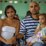 Victor Garcia (R), alias "The Duck" from the Calle 18 gang, sits with his wife and daughter during a religious service at a prison in Quezaltepeque, on the outskirts of San Salvador June 16, 2012. The relentless tit-for-tat murders between El Salvador's two largest street gangs - "Calle 18" and "Mara Salvatrucha" - made the country the most murderous in the world last year after neighboring Honduras, also ravaged by gang violence. That was until Garcia, from the Calle 18 ("18th Street") gang, along with elders from the Mara Salvatruchadeclared an unprecedented truce that authorities say has cut the homicide rate in half in just four months. Picture taken June 16, 2012. REUTERS/Ulises Rodriguez