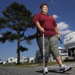 Harriet Bowen, who had hip replacement surgery, walks near her trailer at the Treasure Beach trailer park in Selbyville, Delaware, June 27, 2012. REUTERS/Tim Shaffer