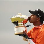 India's Jeev Milkha Singh kisses the winners trophy during a presentation after winning the Scottish Open golf tournament after an extra hole play off against Italy's Francesco Molinari at Castle Stuart golf course near Inverness, Scotland July 15, 2012. REUTERS/David Moir