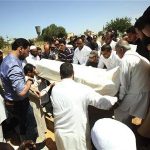 Men prepare to bury the body of former oil chief Shokri Ghanem, who defected during the anti-Gaddafi revolt last year, during a funeral ceremony at a cemetery in Tripoli May 4, 2012. REUTERS/Ismail Zitouny