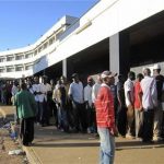 Residents queue up for sugar at a supermarket in the Malawian capital of Lilongwe April 7, 2012. REUTERS/Jon Herskovitz