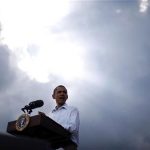 U.S. President Barack Obama stands under the sun breaking through clouds at a town hall-style event in Alpha, Illinois August 17, 2011. REUTERS/Jason Reed