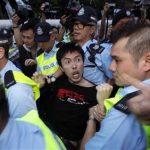 A pro-democracy demonstrator is arrested by the police after jumping the security fence, during a protest in front of the hotel where Chinese President Hu Jintao is staying, in Hong Kong June 30, 2012, a day before the 15th anniversary of the territory's handover to China. REUTERS/Tyrone Siu