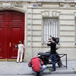 Journalists stand in front of the entrance of a building housing the new offices of former French President Nicolas Sarkozy in Paris July 3, 2012. REUTERS/Mal Langsdon
