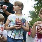 Benjamin, 8, Alana, 10, and Sara Lesczynski (L-R), 8, of New York, hold "Big Gulp" drinks while protesting the proposed "soda-ban," that New York City Mayor Michael R. Bloomberg has suggested, outside City Hall in New York July 9, 2012. REUTERS/Andrew Burton