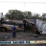 A policeman looks on as the remains of a truck, which collided with a train, is towed away in the eastern Mapumalanga province, between the city of Nelspruit and the Mozambique border, July 13, 2012. REUTERS/Siphiwe Sibeko